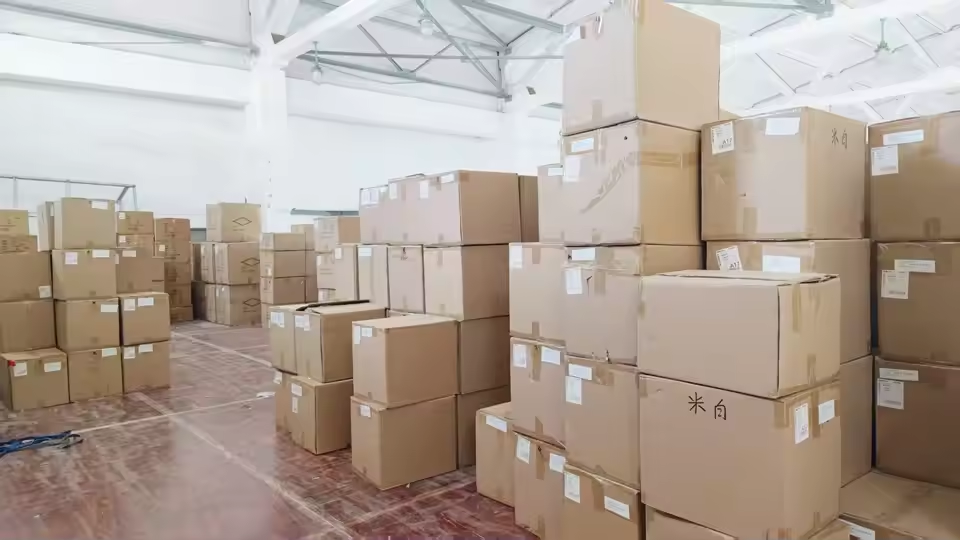 Warehouse filled with finished jewelry packaging boxes ready for shipment — illustrating the transit and storage conditions that moisture-barrier packaging must withstand